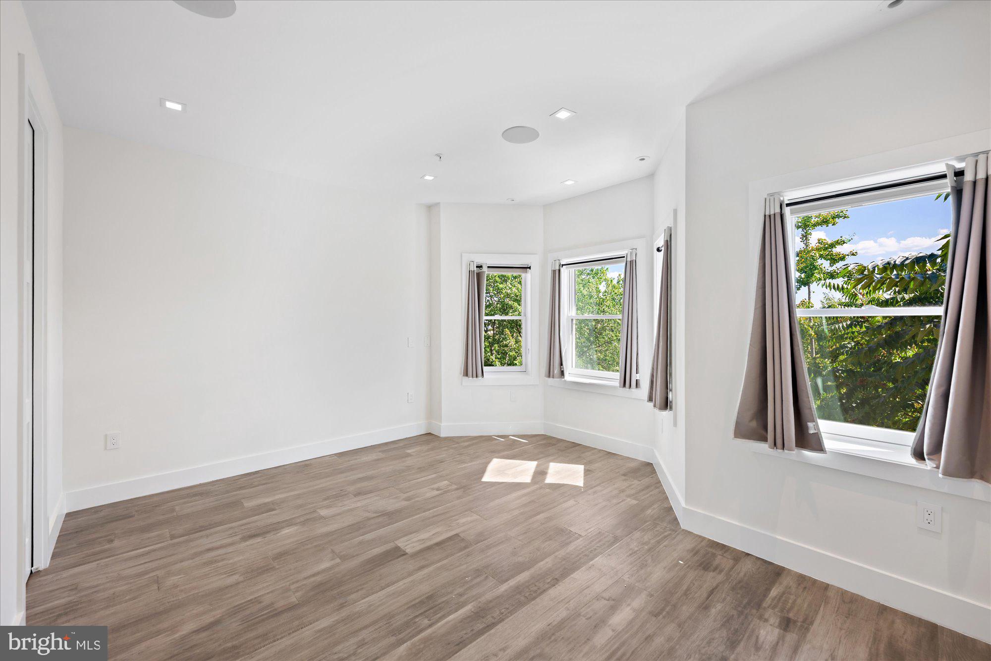 1777 T Street Northwest, Unit 5 Washington, DC 20009 - Photo 33 of 48 an empty room with wooden floor and windows