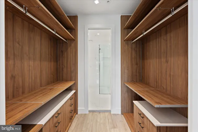 a kitchen with a wooden floor and cabinets