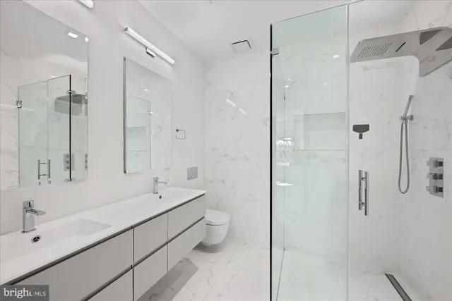 a bathroom with a double vanity sink mirror and shower