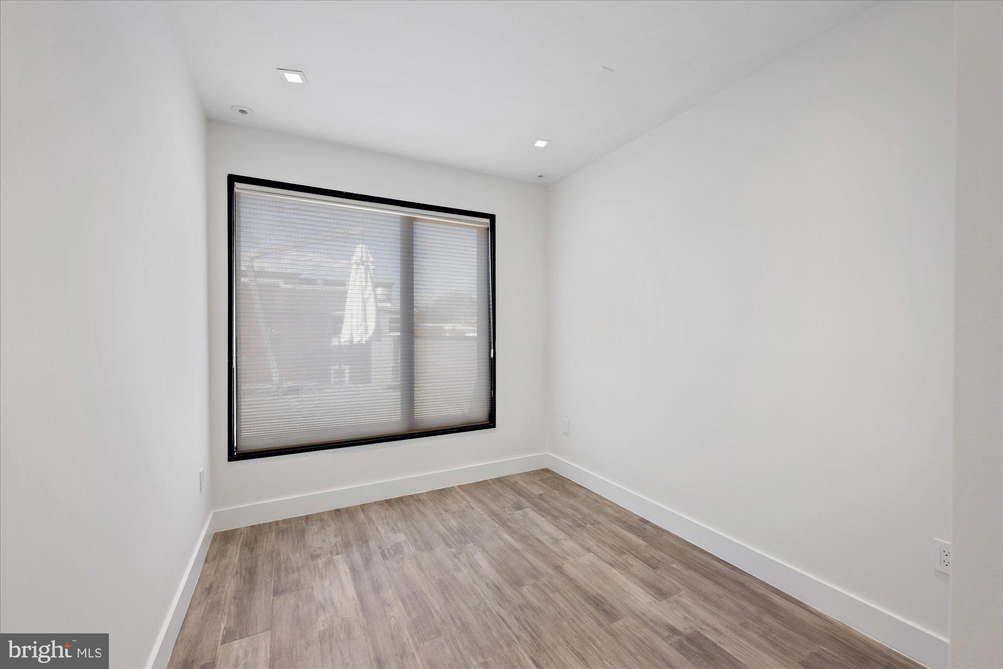 1777 T Street Northwest, Unit 5 Washington, DC 20009 - Photo 39 of 48 a view of an empty room with wooden floor and a window