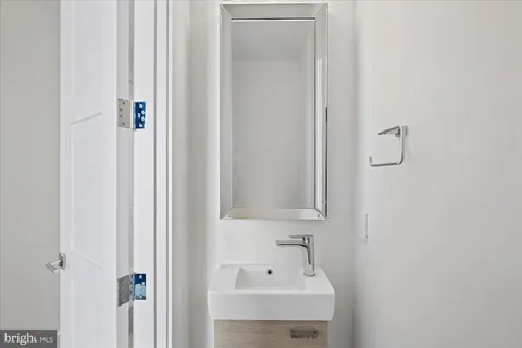 a bathroom with a sink a mirror and shower