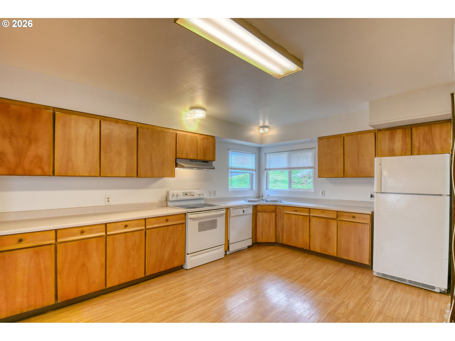 1716 Southeast Court Avenue Pendleton, OR 97801 - Photo 14 of 43 a kitchen with lots of counter top space and wooden floor