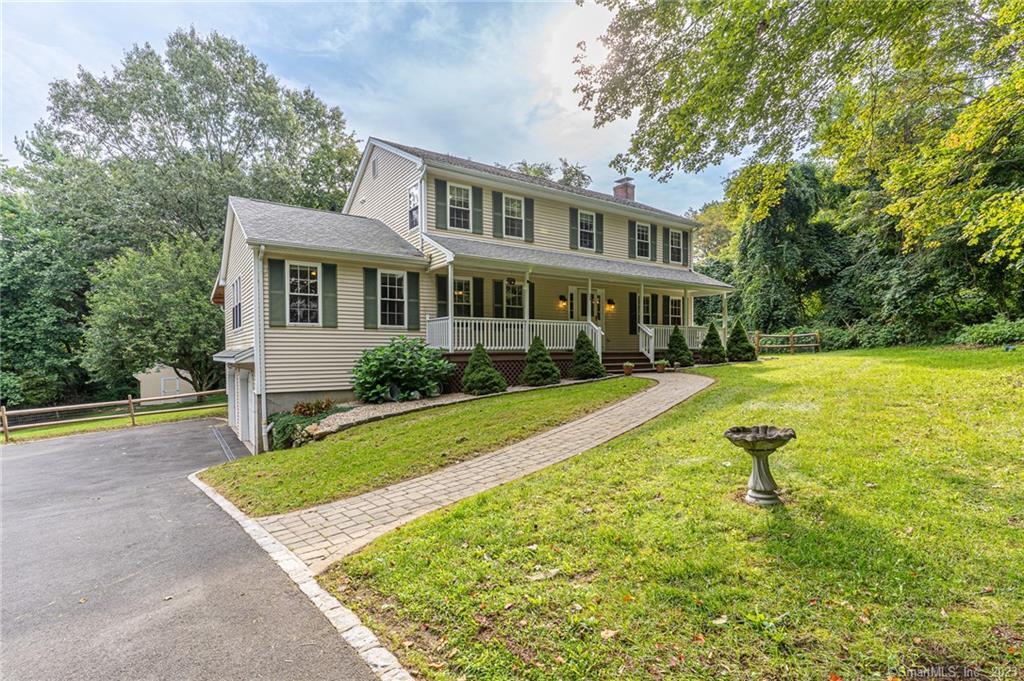a view of a house with a yard patio and swimming pool