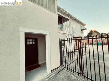 a view of a house with wooden fence