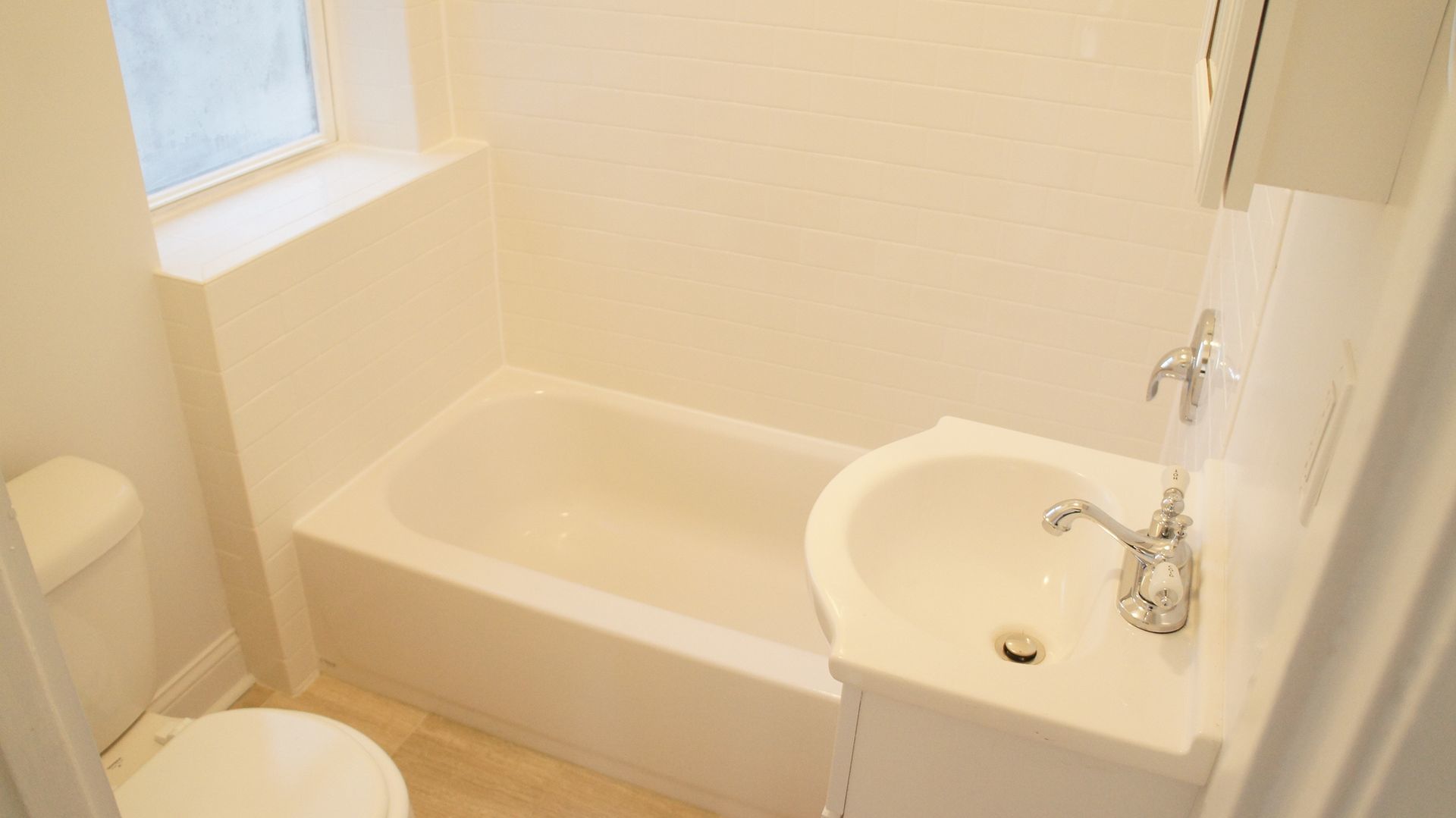 2921 West George Street, Unit 1 Chicago, IL 60618 - Photo 6 of 6 a bathroom with a granite countertop sink and a mirror