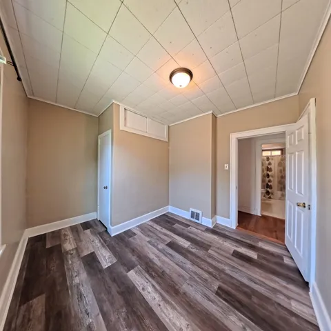 a view of a room with wooden floor