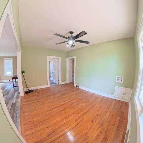 a bedroom with a bed and a ceiling fan