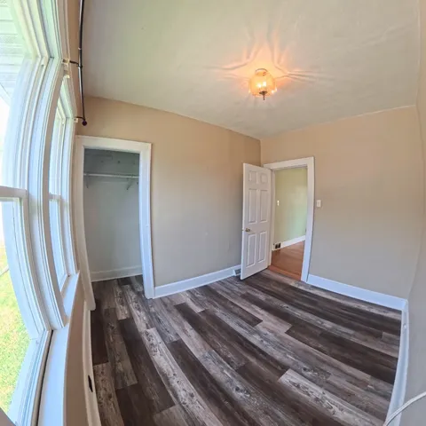 a view of a room with wooden floor and stairs