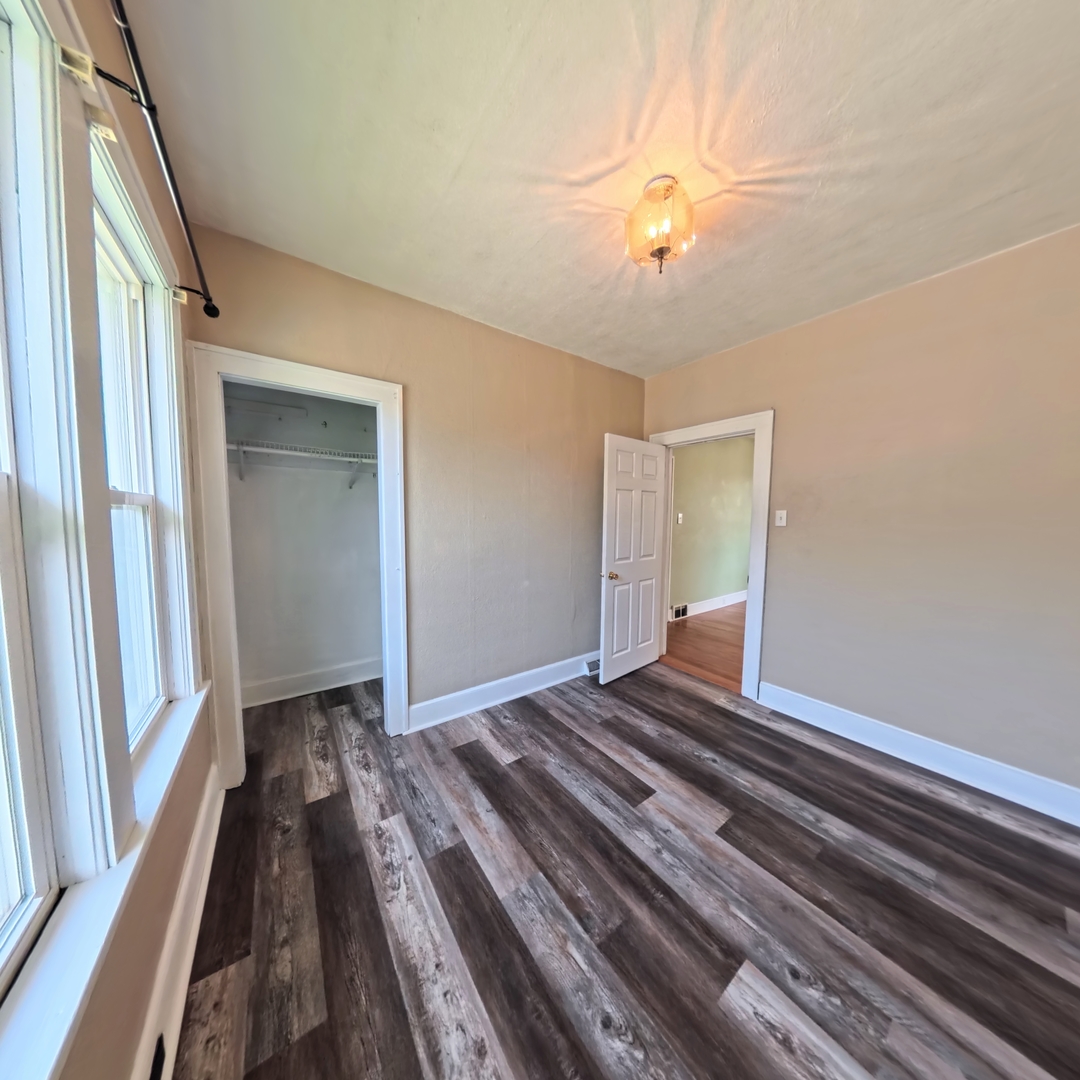 118 West 3rd Street Streator, IL 61364 - Photo 13 of 29 a bedroom with a bed and a chandelier