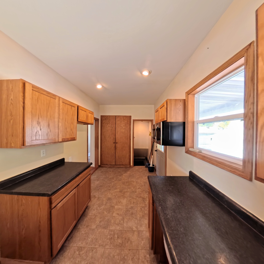 118 West 3rd Street Streator, IL 61364 - Photo 16 of 29 a large kitchen with stainless steel appliances granite countertop a sink and a stove