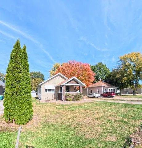 a view of house with garden and deck