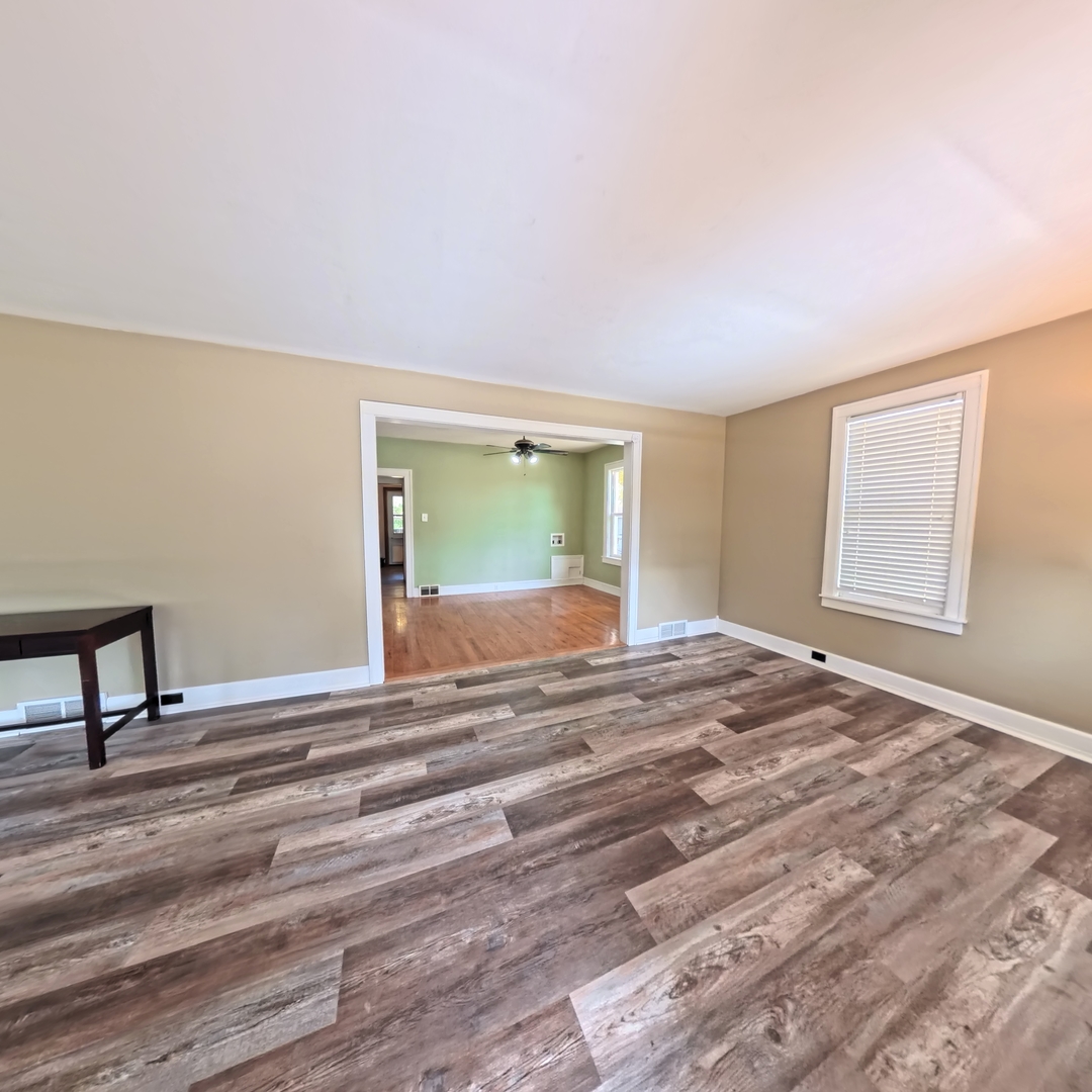 118 West 3rd Street Streator, IL 61364 - Photo 5 of 29 a view of a room with wooden floor and a window