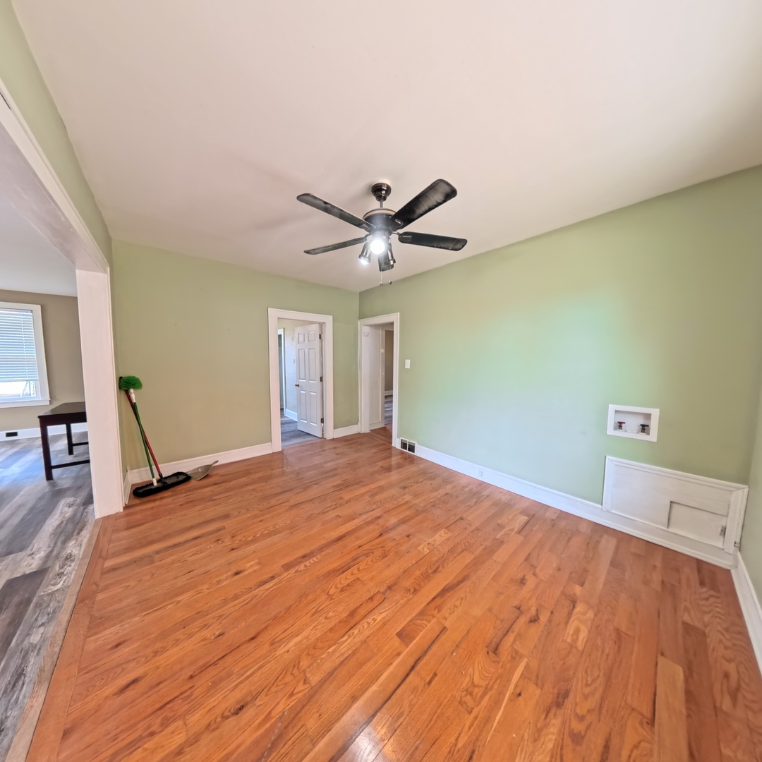 118 West 3rd Street Streator, IL 61364 - Photo 9 of 29 a workspace with wooden floor and ceiling fan