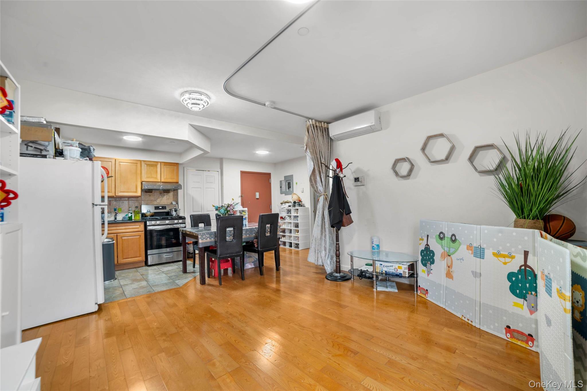 58-04 Main Street, Unit 1A Queens, NY 11355 - Photo 9 of 21 a living room filled with furniture and a dining table with chairs