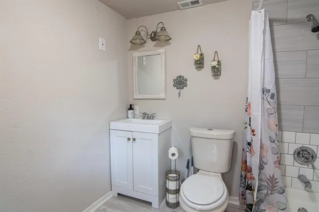 a white toilet sitting next to a bathroom sink