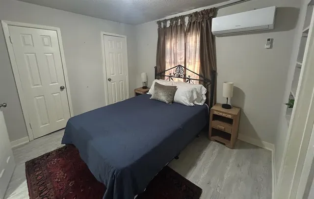 a bedroom with a bed and a mirror