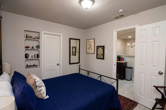 a bedroom with a bed and a view of bedroom