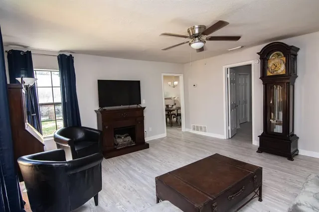 a living room with furniture flat screen tv and a fireplace
