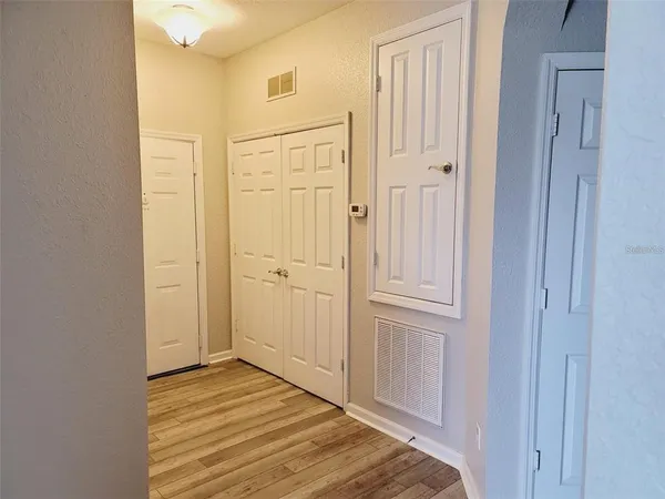 a view of a livingroom with wooden floor and closet area