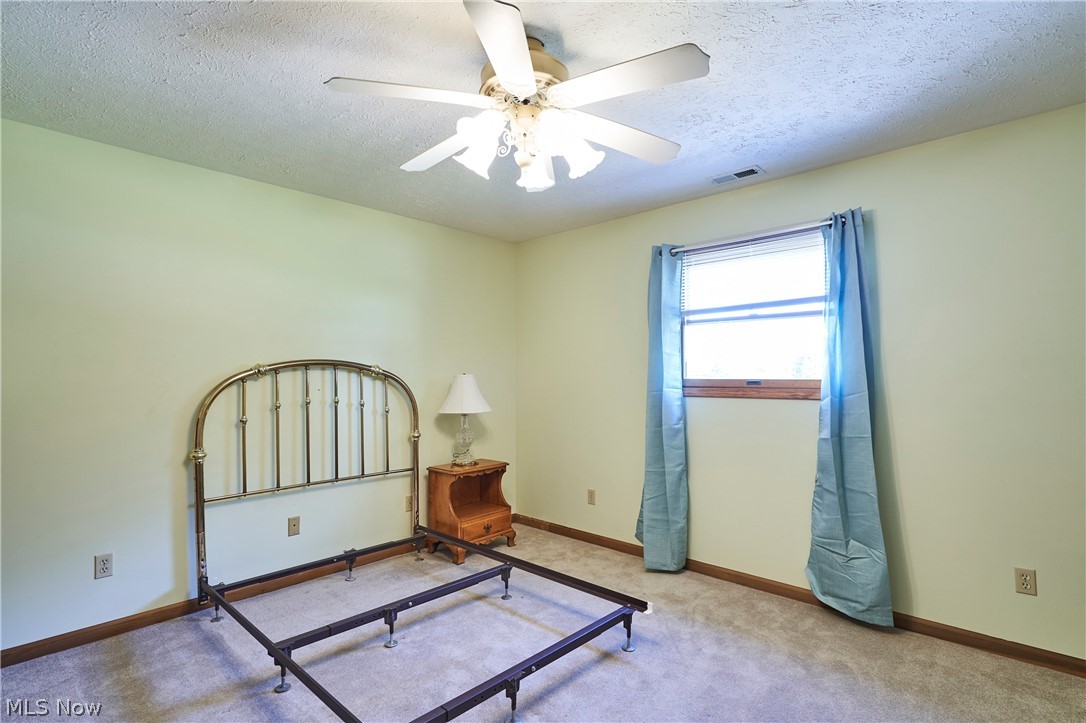 1121 Novak Road Grafton, OH 44044 - Photo 37 of 37 2nd Floor Bedroom featuring carpet, ceiling fan, and a textured ceiling
