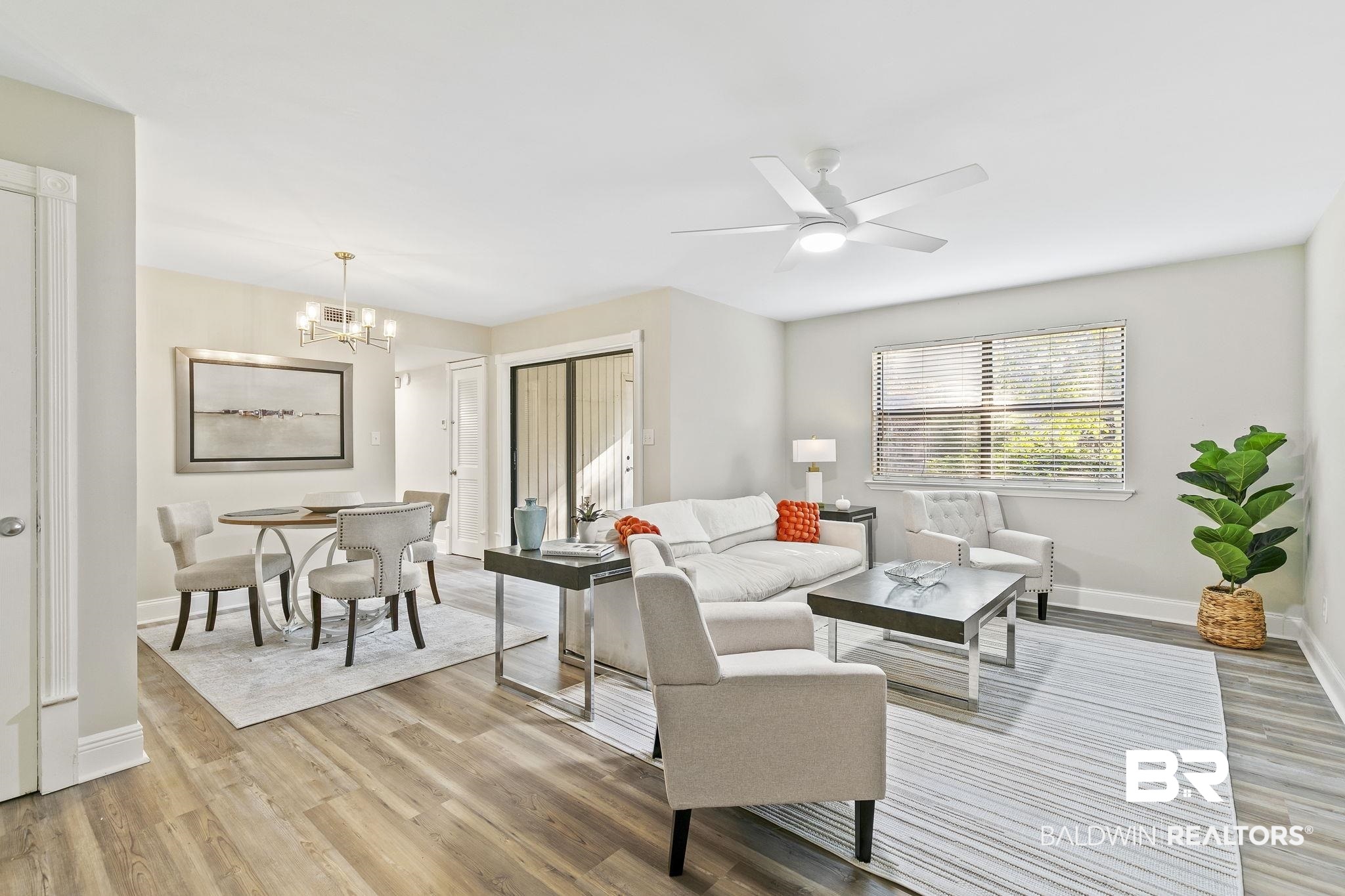 110 5th Street, Unit C103 Daphne, AL 36526 - Photo 6 of 46 Living room featuring ceiling fan with notable chandelier and light hardwood / wood-style floors
