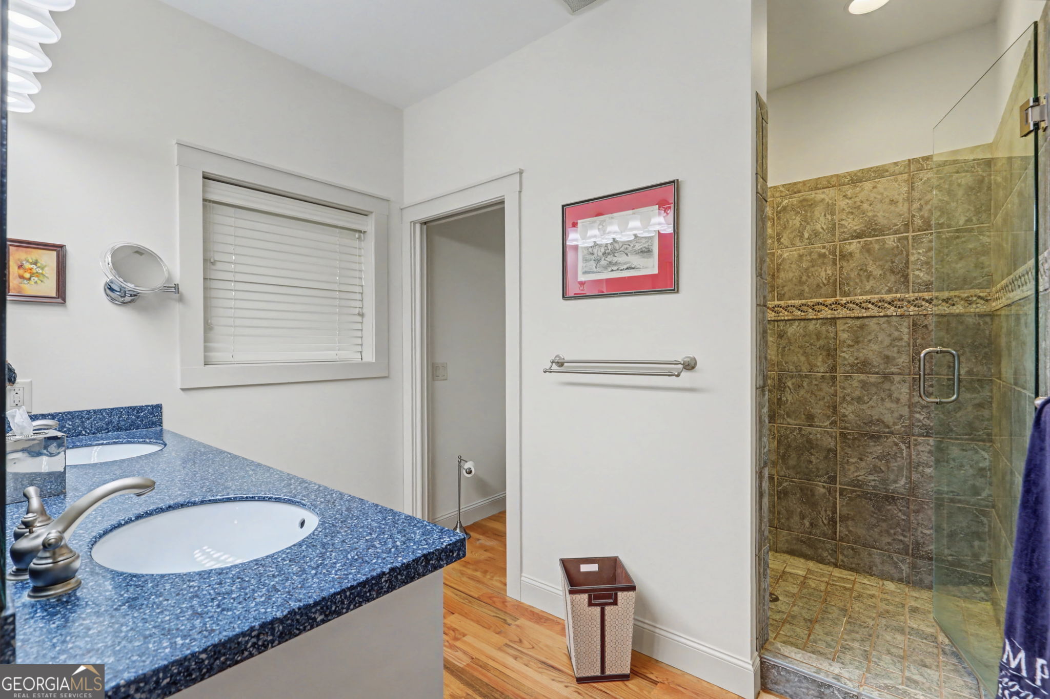 1176 Tiger Pass Drive Tiger, GA 30576 - Photo 44 of 67 a bathroom with a granite countertop sink a mirror and a shower