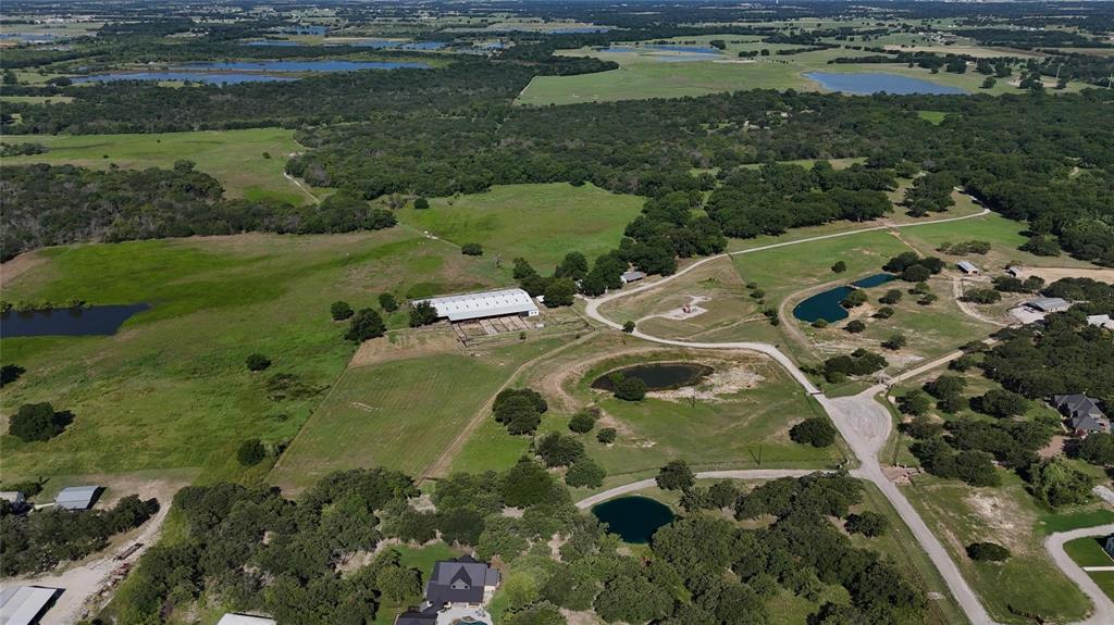 377 Private Road 3249, Unit ARENA Decatur, TX 76234 - Photo 38 of 40 a view of a lake with a yard