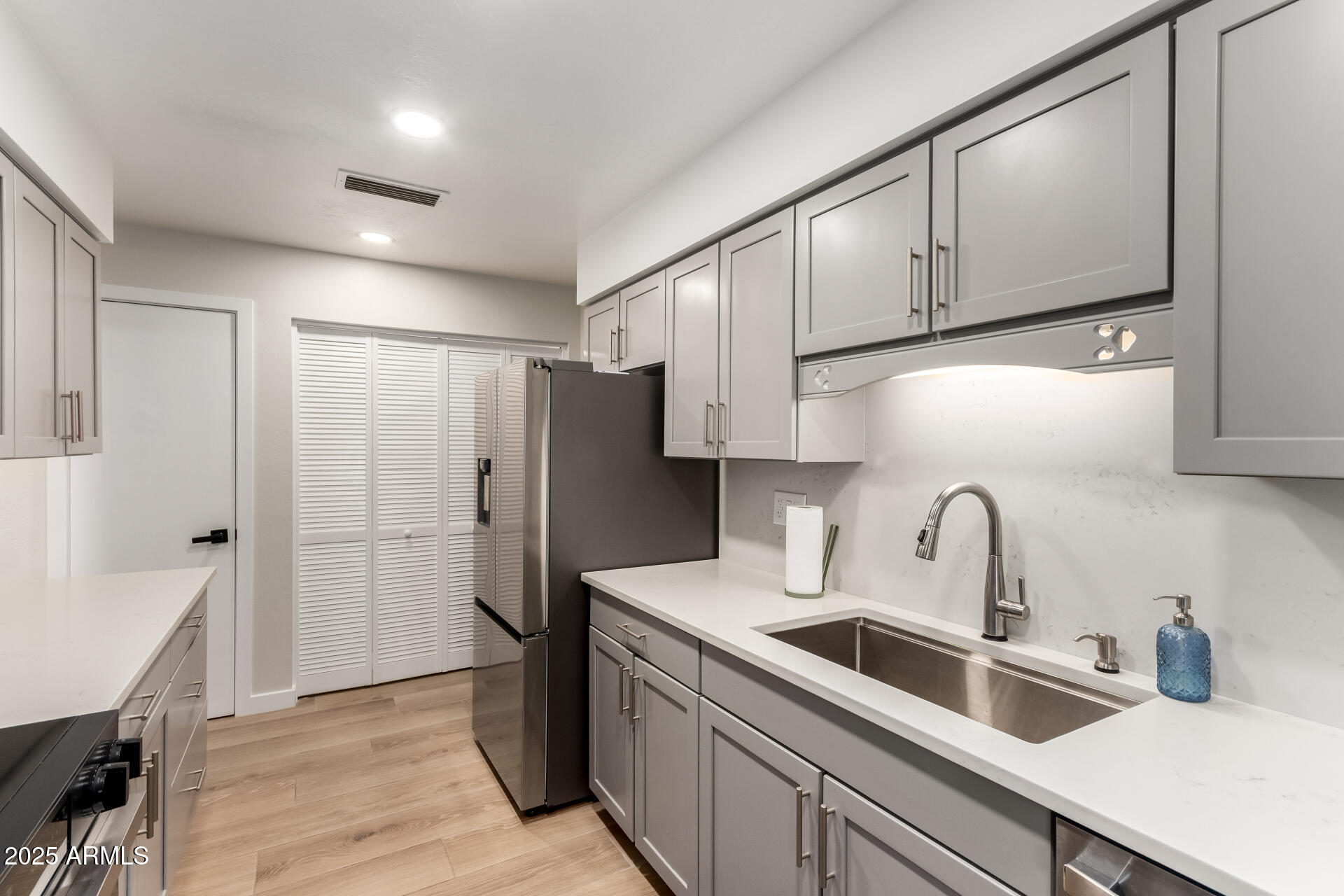 1207 East Northshore Drive, Unit 136 Tempe, AZ 85283 - Photo 10 of 49 a kitchen with stainless steel appliances a refrigerator sink and cabinets