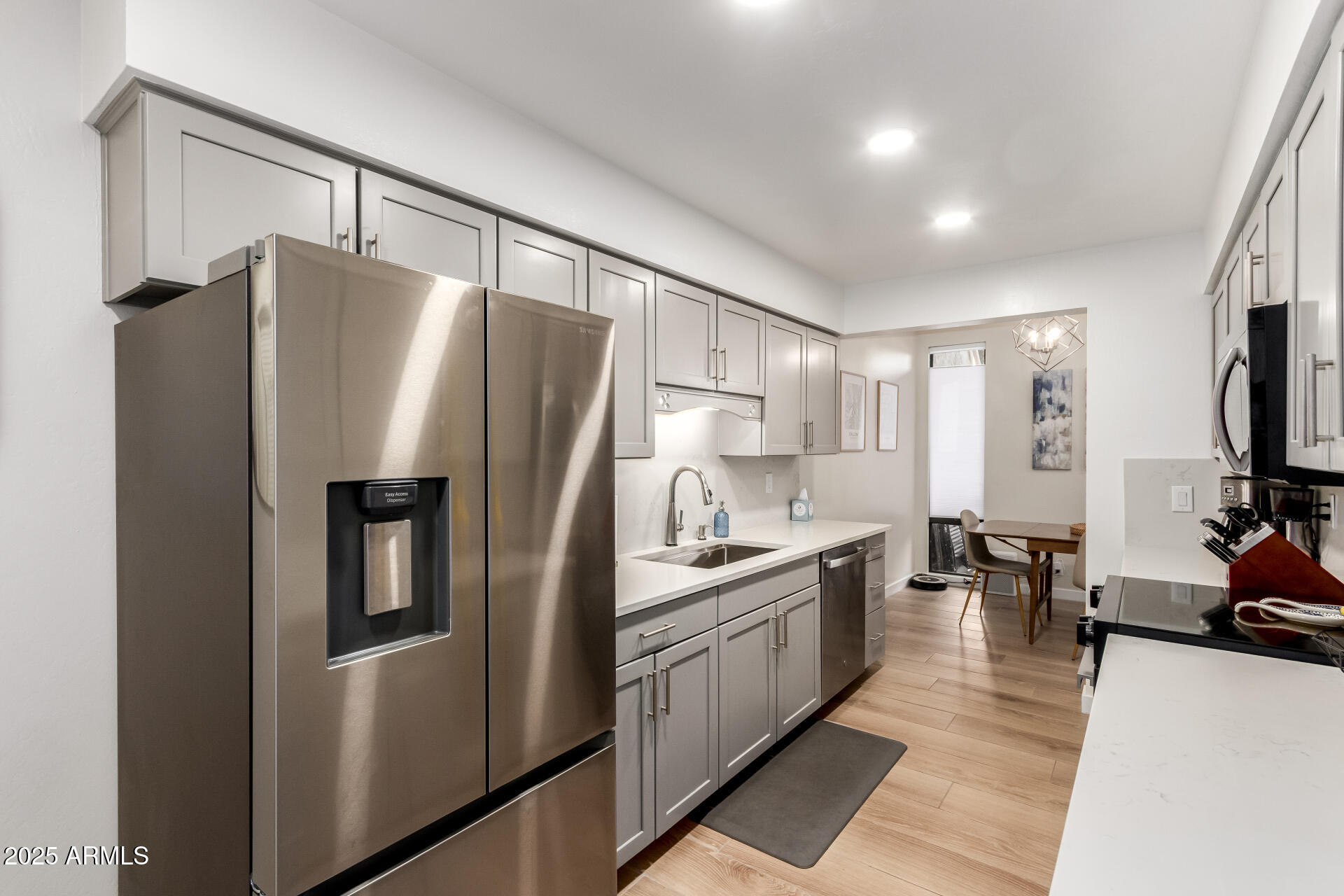 1207 East Northshore Drive, Unit 136 Tempe, AZ 85283 - Photo 11 of 49 a kitchen with stainless steel appliances a refrigerator sink and stove