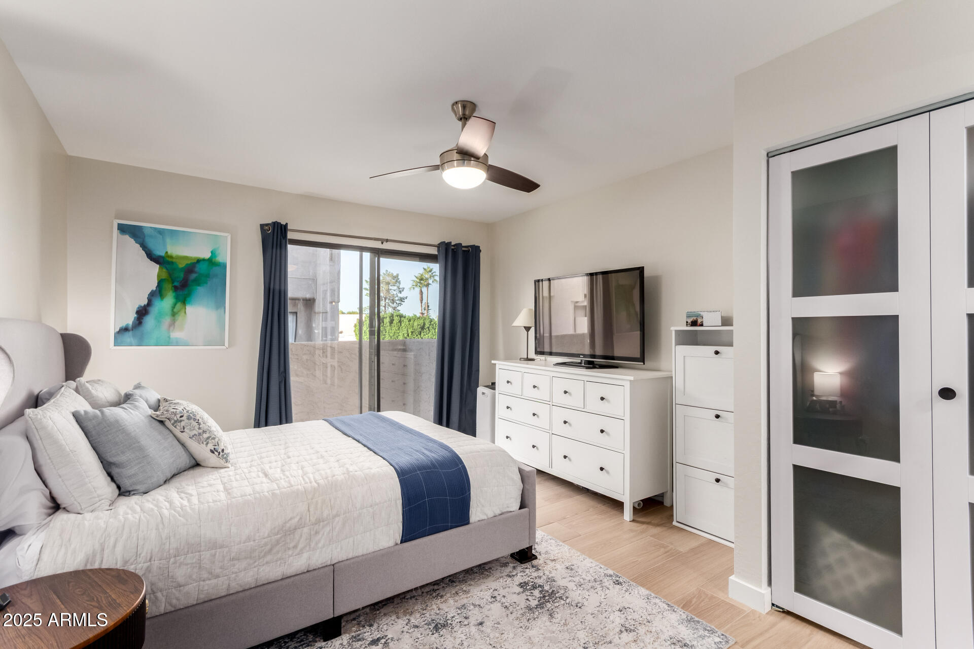 1207 East Northshore Drive, Unit 136 Tempe, AZ 85283 - Photo 17 of 49 a bedroom with a large bed and flat tv screen on dresser