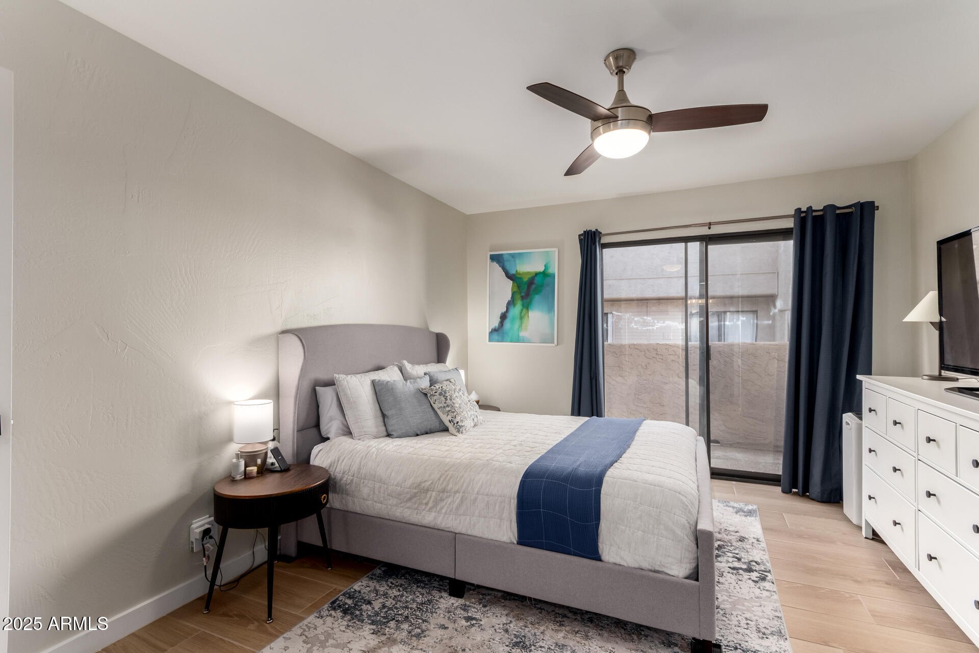 1207 East Northshore Drive, Unit 136 Tempe, AZ 85283 - Photo 18 of 49 a bedroom with a bed and a flat tv screen on dresser