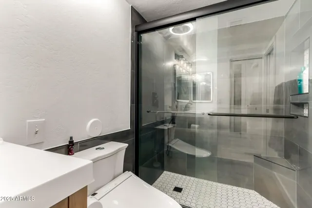 a bathroom with a sink mirror and vanity