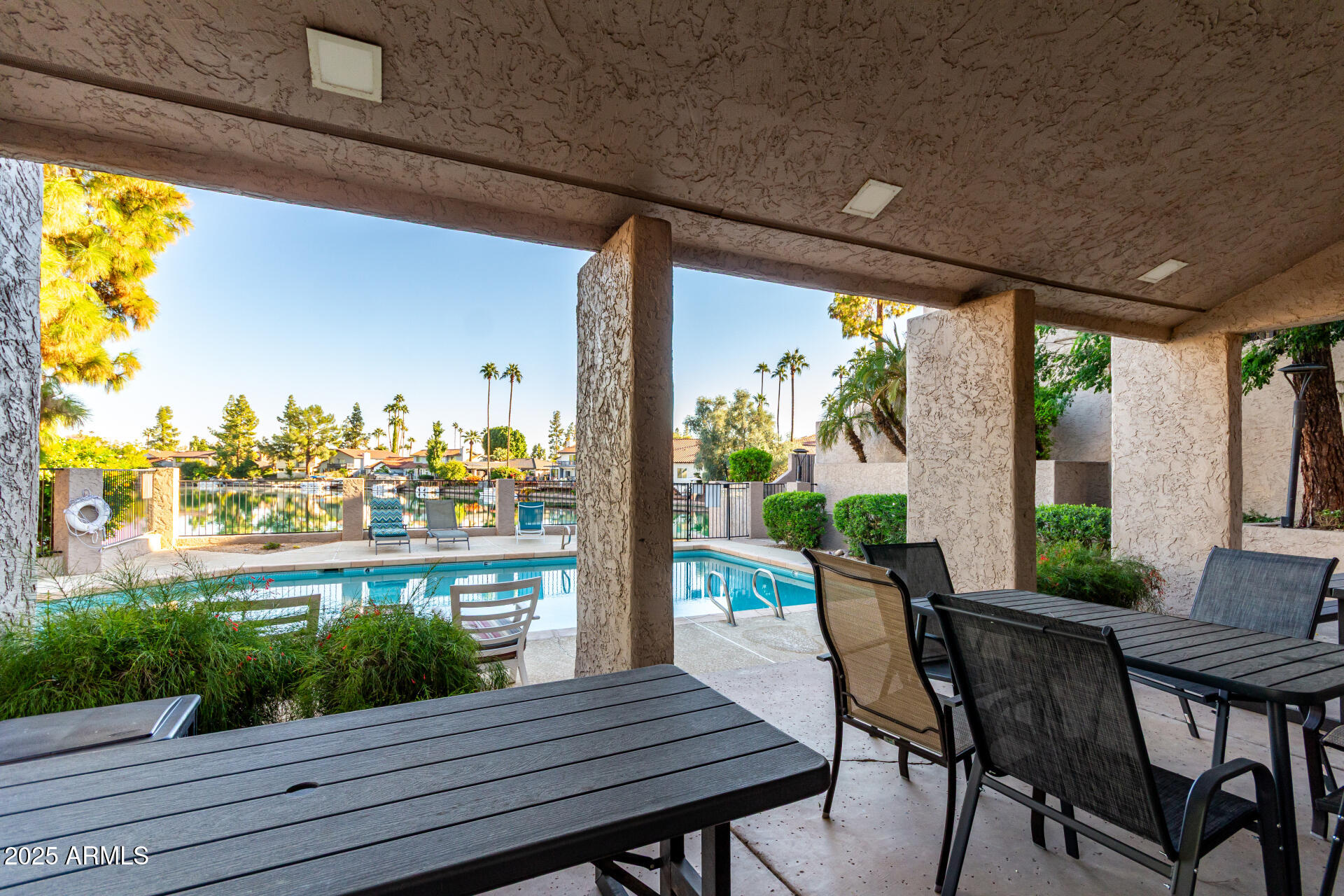 1207 East Northshore Drive, Unit 136 Tempe, AZ 85283 - Photo 28 of 49 a view of a patio with table and chairs and potted plants