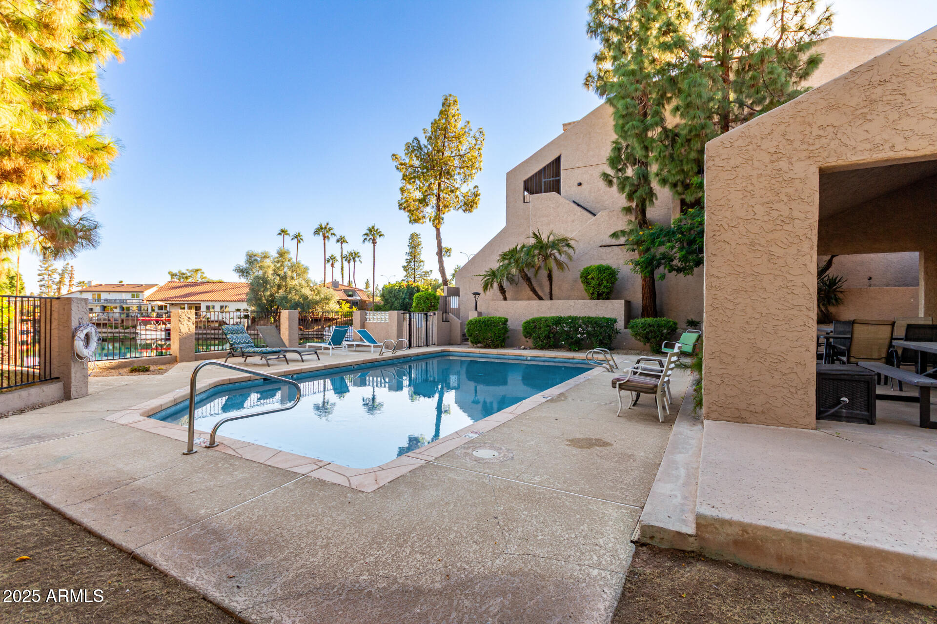 1207 East Northshore Drive, Unit 136 Tempe, AZ 85283 - Photo 29 of 49 a view of a swimming pool with a lounge chair