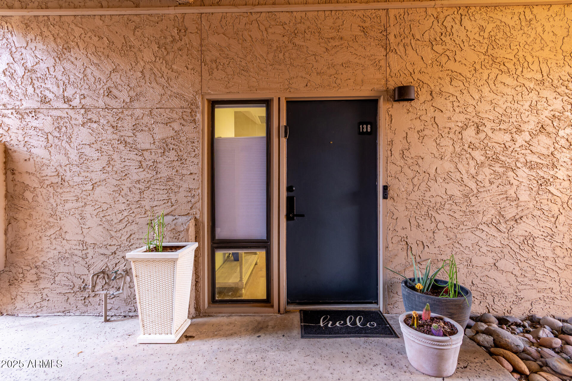 1207 East Northshore Drive, Unit 136 Tempe, AZ 85283 - Photo 2 of 49 a front view of a house with potted plants