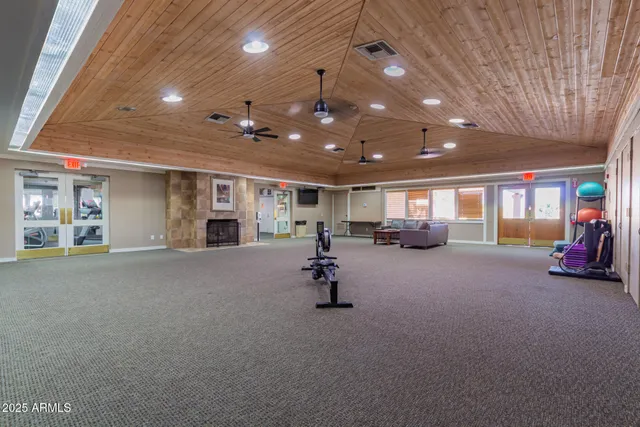 a view of a patio with a dining table and chairs with wooden floor