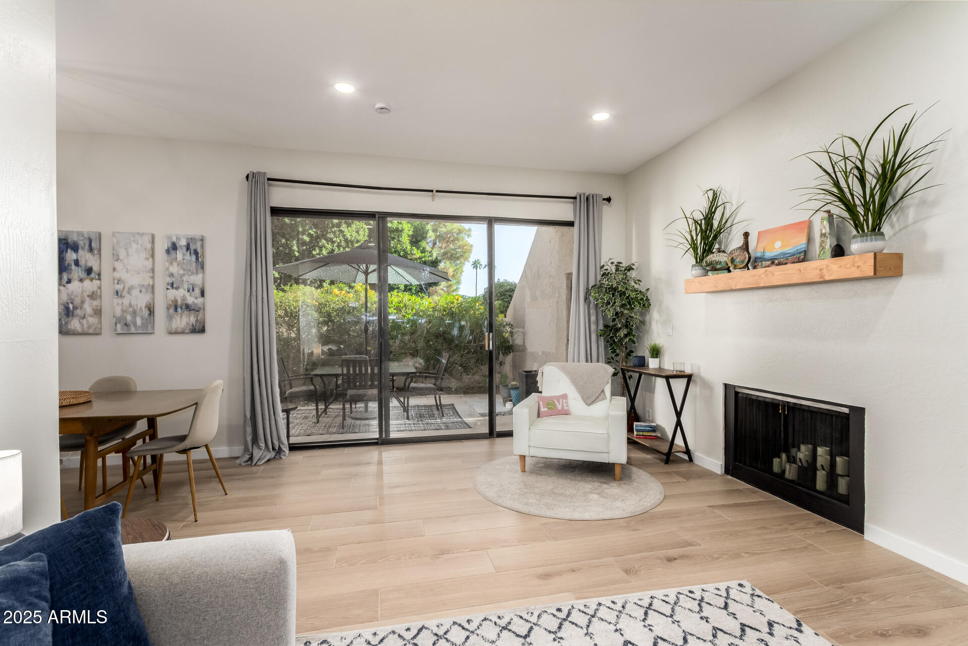 1207 East Northshore Drive, Unit 136 Tempe, AZ 85283 - Photo 5 of 49 a living room with furniture a large window and a fireplace