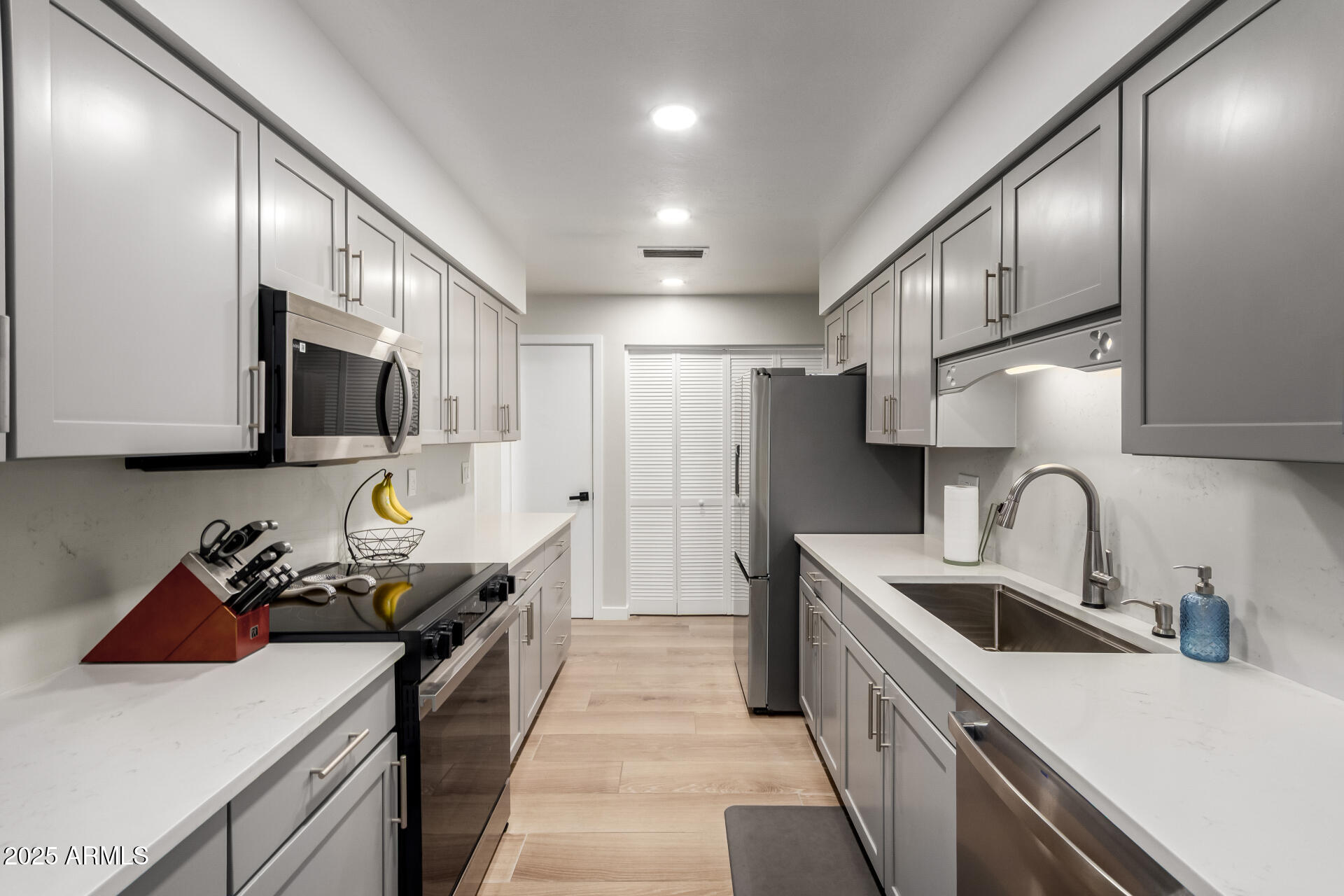 1207 East Northshore Drive, Unit 136 Tempe, AZ 85283 - Photo 8 of 49 a kitchen with stainless steel appliances a sink stove and cabinets