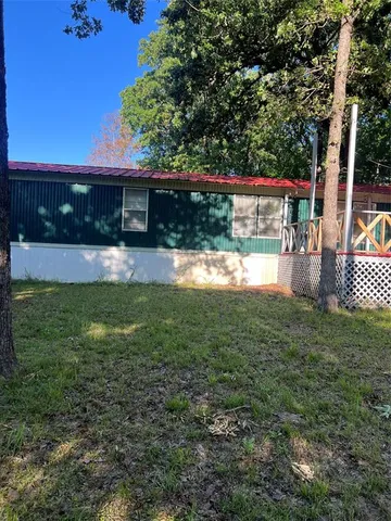 a view of house with backyard outdoor seating and hardwood