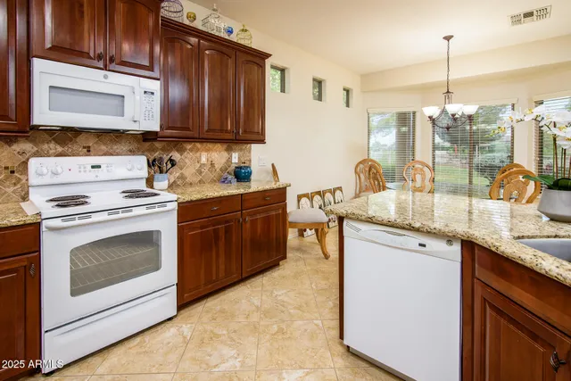 a kitchen with stainless steel appliances wooden cabinets and a stove top oven