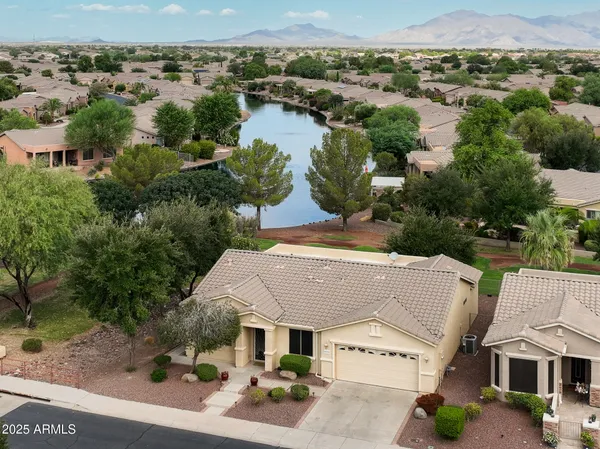 an aerial view of multiple houses with a lake view