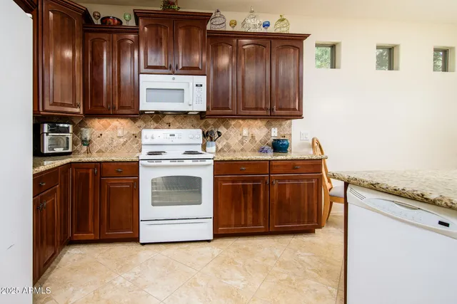 a kitchen with stainless steel appliances granite countertop a refrigerator stove and sink