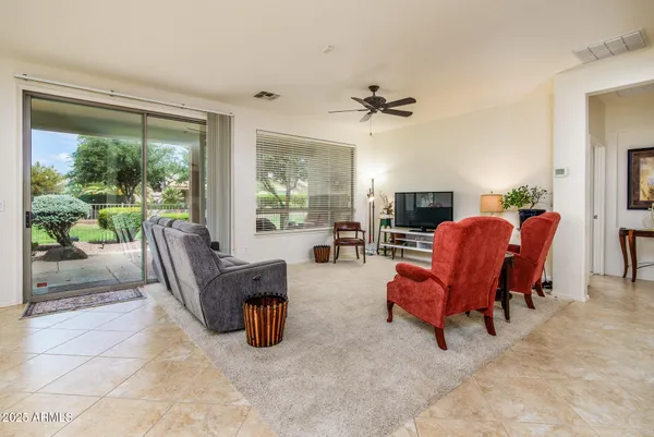 a living room with furniture and kitchen view