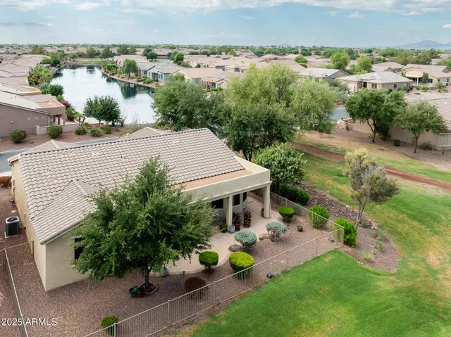 an aerial view of a house with garden space and street view