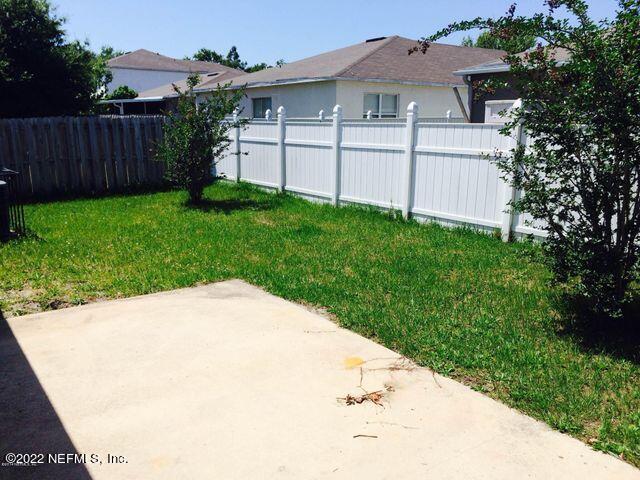 7403 High Bluff Road North Jacksonville, FL 32244 - Photo 3 of 9 a backyard of a house with lots of green space