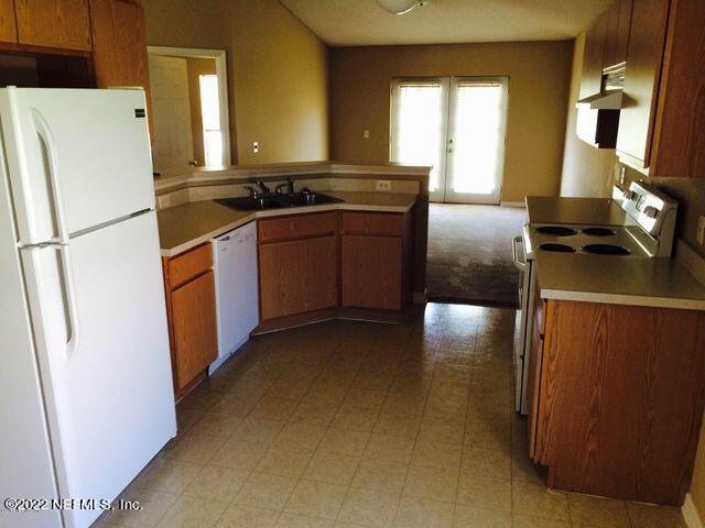 7403 High Bluff Road North Jacksonville, FL 32244 - Photo 6 of 9 a kitchen with stainless steel appliances granite countertop a refrigerator a stove a sink and a refrigerator