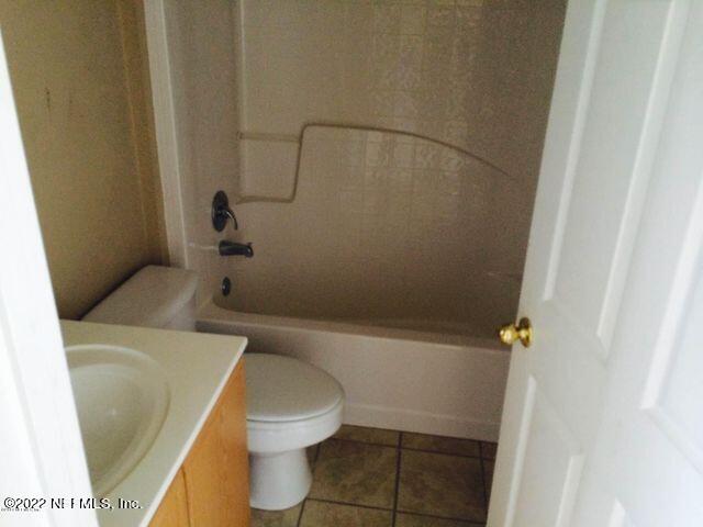 7403 High Bluff Road North Jacksonville, FL 32244 - Photo 7 of 9 a white toilet sitting next to a bath tub
