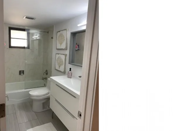 a bathroom with a sink toilet and shower