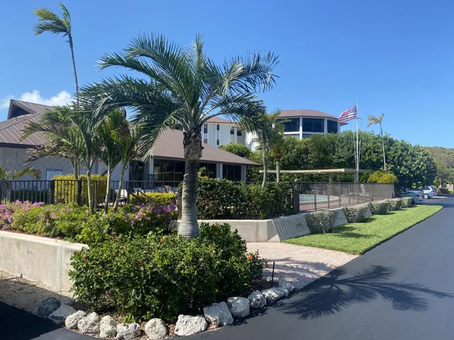 a front view of a house with a garden and yard