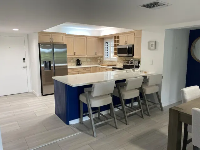 a view of kitchen with cabinets counter top space and stainless steel appliances